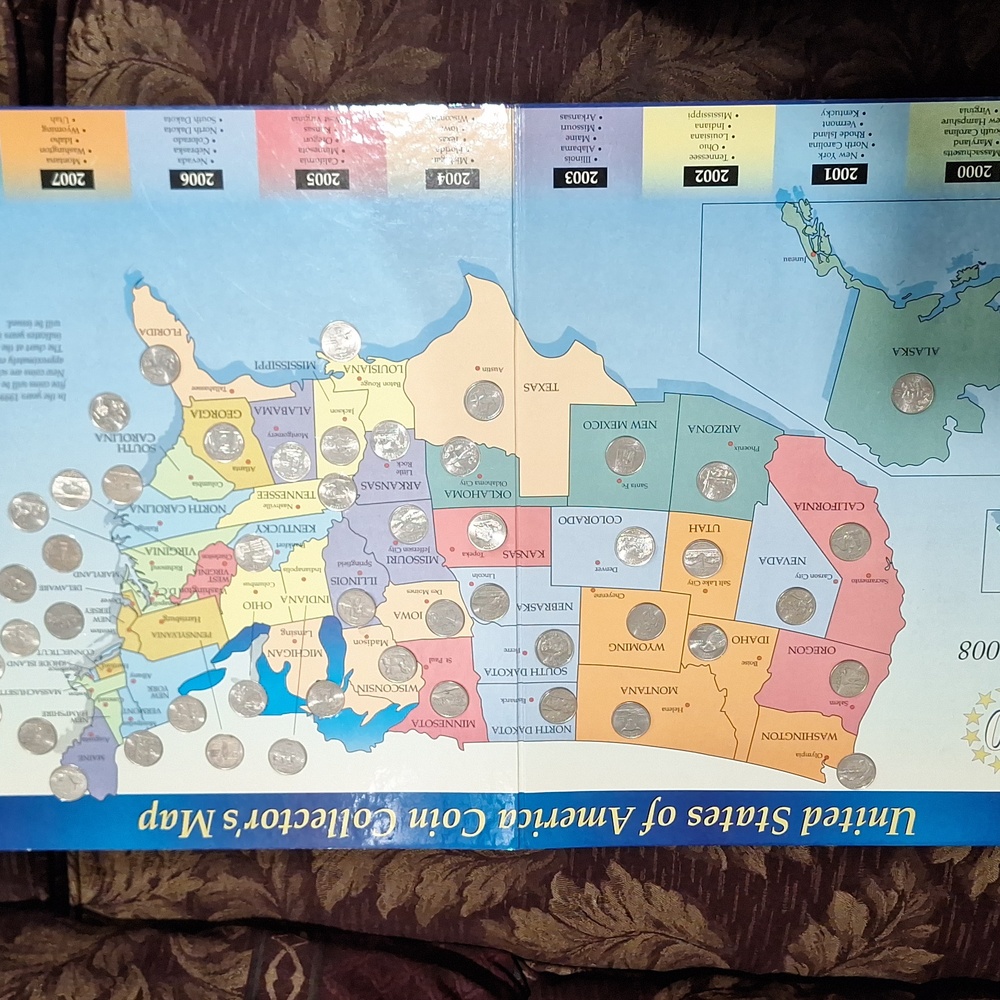 Collectors album with all 50 States quarter coins.